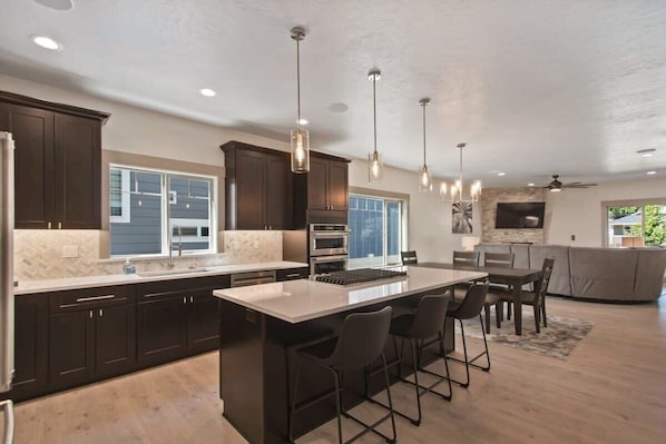 Enjoy cooking your meals in this top-of-the-line kitchen overlooking the dining area and living room