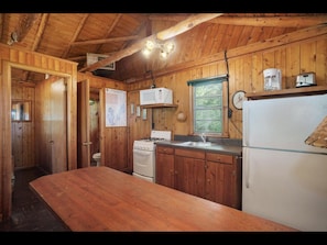kitchen has stove, refrigerator, microwave, toaster and coffeemaker