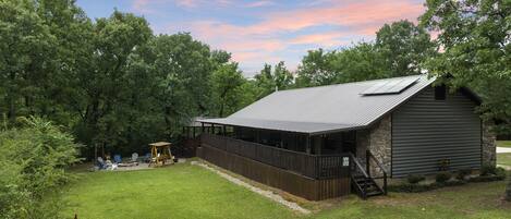 Great open area in front of covered porch for playing with the firepit at the end.