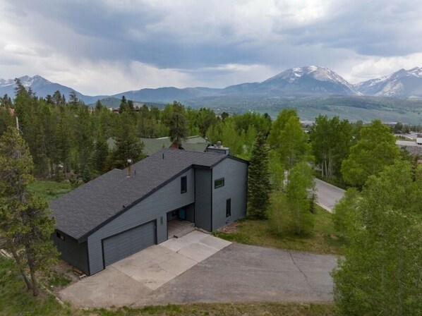 Exterior view of the front of the property with beautiful Buffalo Mountain and Red Mountain peaks in the background.