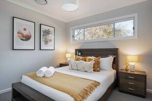  The master bedroom features a queen-size bed and a contemporary ensuite.
