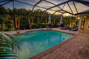 Heat pump heated saltwater pool with waterfall, swimout, and dual level deck. 