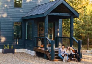 A porch where memories are just waiting to be made, flanked by your loyal fur friends.