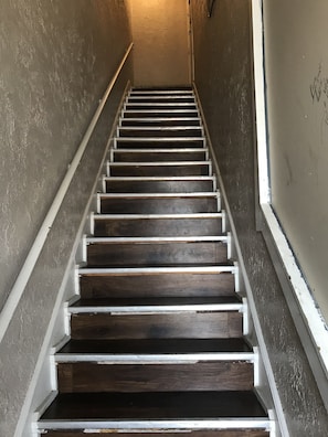 stairs that lead to coded end dry door to apartment quarters