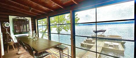 Main Cottage - screened in porch dining and view of dock an lake