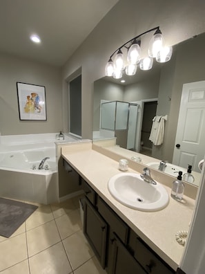Downstairs en-suite bathroom, soaking tub, stand alone shower and toilet room.