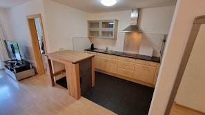 Kitchen and large TV in the living room