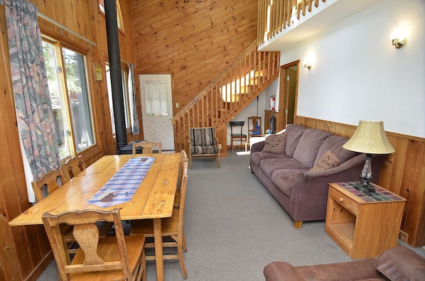 Living room/dining room, overlooking the cabin's fire pit and the 70' pier-swim.