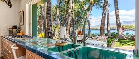 One of a kind artful kitchen area with open views looking out at ocean and coast