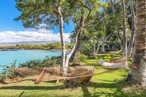 Enjoy the sounds of gentle waves as you relax in a hammock by the sea