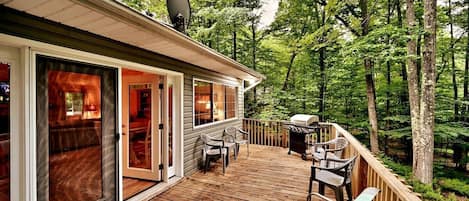 Step outside the back door and onto the deck with gorgeous wooded views as far as the eye can see. There's nothing quite like the aroma of fresh mountain air.  Deck furnished with ample seating and a charcoal BBQ grill & grill tools.