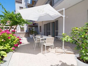 Plant, Building, Flower, Table, Window, Shade, Chair, Outdoor Furniture, Sky, Residential Area