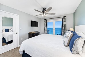 Primary Bedroom with balcony entrance and King size bed