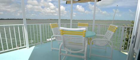 deck table and chairs overlooking ocean