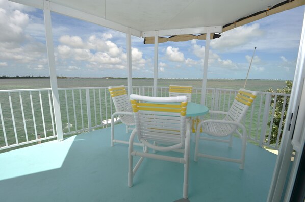 deck table and chairs overlooking ocean