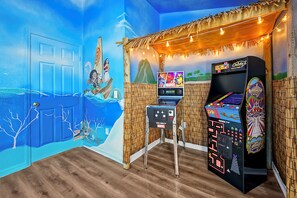 Game Room: Dive into fun with arcade games and vibrant beach-themed murals!