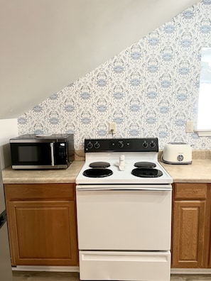 Kitchen is equipped w/ Stove, microwave, fridge, 2 coffee makers - no dishwasher