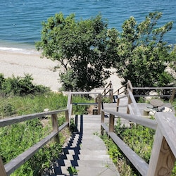 Short staircase to beach from backyard. Beach chairs and towels provided