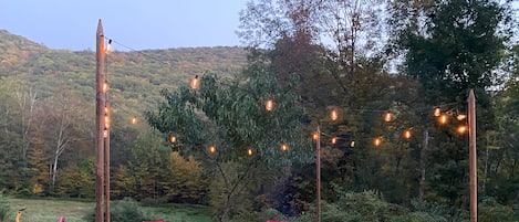 Wood fire pit with seating and solar lights surrounded by amazing mountain views