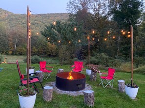 Wood fire pit with seating and solar lights surrounded by amazing mountain views