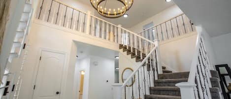 Ascend with grace and style as you traverse the elegant stairs leading to the upstairs area. The carefully designed staircase combines functionality with aesthetics, featuring sleek handrails, polished steps, and a seamless integration.