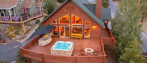 AERIAL VIEW OF THE BACK OF THE HOUSE/BACK DECK.
INCLUDES JACUZZI TUB, FIRE PIT, AND ISLAND BBQ!