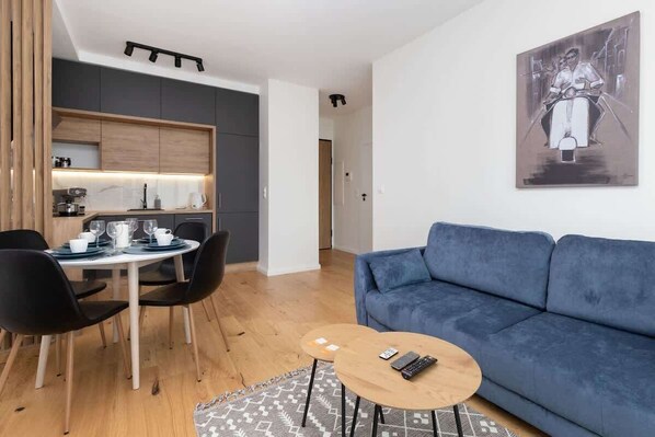 The living room features two sleek coffee tables and a flat-screen television.