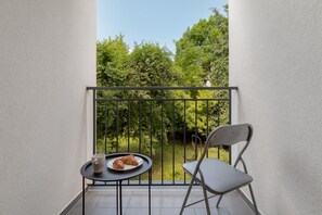The balcony provides a tranquil spot for enjoying a book. 