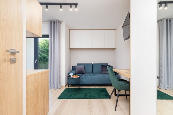 Relax in the stylish living area with a comfortable sofa and modern decor.