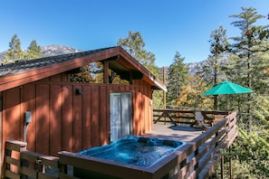 Side of house w/hot tub & sliding door to Bedroom 1.