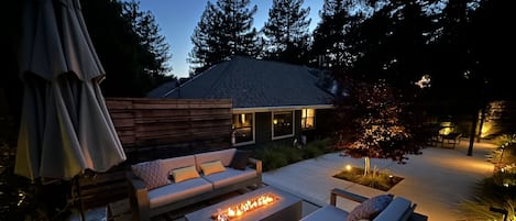 Front patio with fire pit and 8 person dining area. 