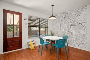 Cozy kitchen with breakfast table and mural of Austin