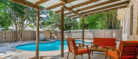 Backyard with relaxing patio, gas grill, and private pool