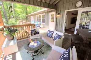 Covered deck, lake views, charcoal grill & fire table.