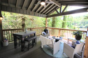 Covered deck, lake views, charcoal grill & fire table.