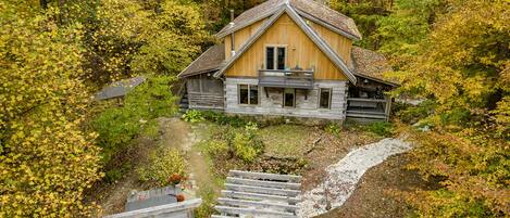 Aerial views of the cabin, pergola, hot tub screen, pond and gardens.