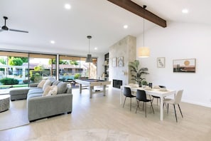 California Desert inspired décor! Open concept living area featuring dining area, a pool table and plush sofa.