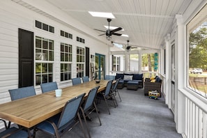 Screened in porch with a table that seats 10