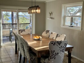 Hardwood dining table with 8 comfy upholstered dining chairs.