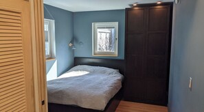 Main bedroom with Queen bed, a spacious wardrobe, and closet space.  