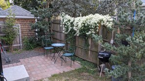 Guests' patio, one step from the dining area through a sliding door.