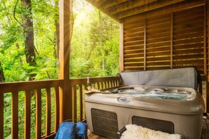 Hot Tub Retreat: Unwind in the bubbling hot tub surrounded by lush forest serenity!