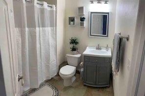 Private detached updated cozy bathroom, with shower & bathtub.