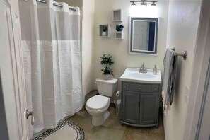 Private detached updated cozy bathroom, with shower & bathtub.