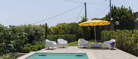 Water, Plant, Property, Sky, Swimming Pool, Shade, Umbrella, Outdoor Furniture, Building, Grass