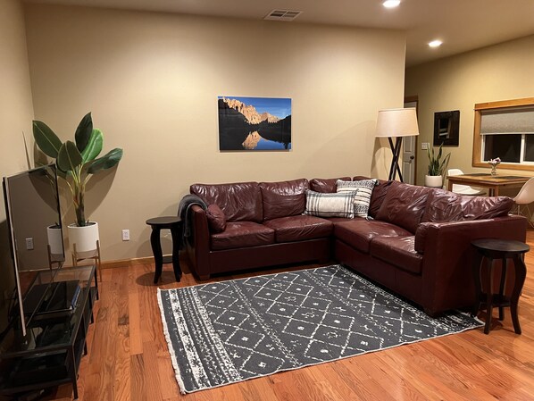 Relax on comfy couch and enjoy streaming Netflix in well lit space.