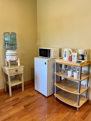 Kitchenette with all the basics including fridge, microwave, coffee pot, kettle.