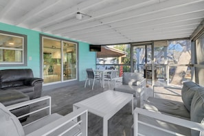 Sliding glass doors from the kitchen lead out to the spacious outdoor living space.