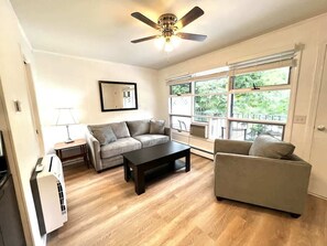 A well lighted living room with the view of the outside while you relax