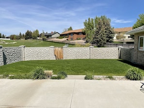 Private fenced yard with grill and patio furniture